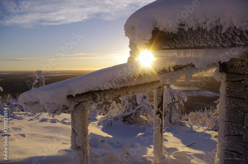Frozen hut and sunset in Finland