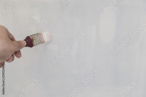 Painting of walls in a white color. Repair in a house.