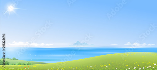 Landscape with green hills and the sea in the distance on a clear day