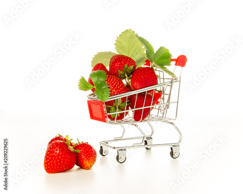 Strawberry in the mini shopping trolley, ripe red berries