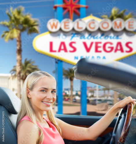 Photography travel, road trip and people concept - happy young woman driving convertible car