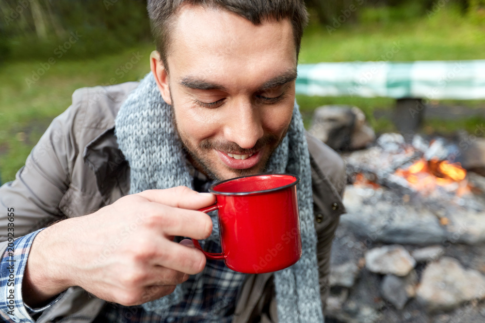 travel, tourism and camping concept - close up of smiling man drinking from cup at camp travel, tourism and camping concept - close up of smiling man drinking from cup at camp