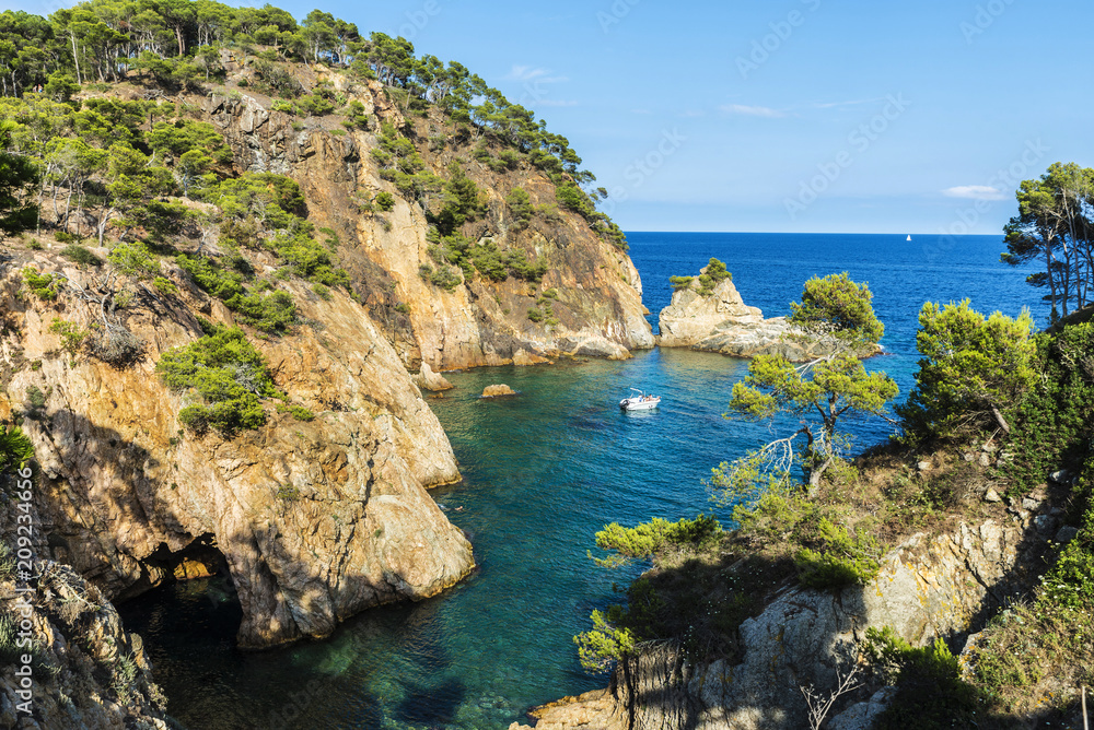 Fototapeta premium Yacht next to cliff in the Costa Brava, Catalonia, Spain