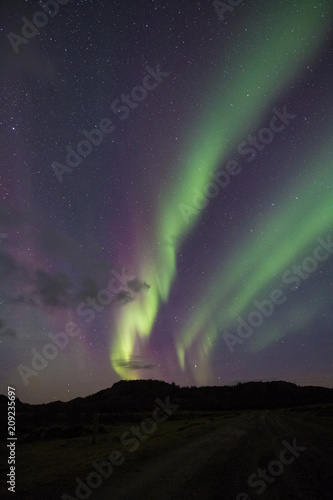 Northern Lights - Aurora borealis. Beautiful picture of massive multicoloured green vibrant Aurora Borealis in the night sky