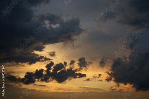 Dark clouds at sunset sky © inilightfx