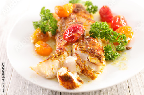 fish fillet with baked tomato