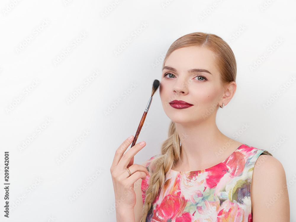 Beauty portrait of young beautiful cheerful young fresh looking make up artist woman with bright trendy make up long blond healthy hair holding cosmetics brush. Beauty portrait of young beautiful cheerful young fresh looking make up artist woman with bright trendy make up long blond healthy hair holding cosmetics brush.