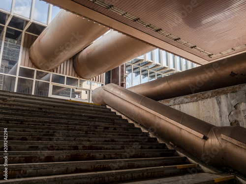 Architecture made in high-tech and brutalist architectural style. Starircase and pipes, pipeline, ducting photo