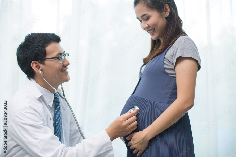 Fototapeta premium Young preganant woman expecting a baby doctor visit