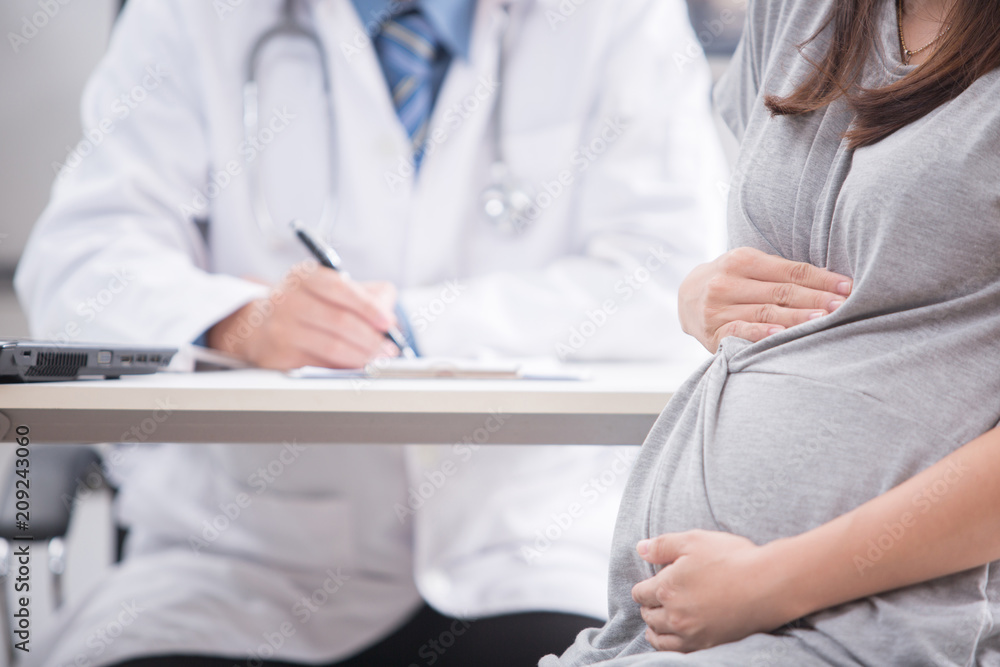 Portrait of pregnant woman with doctor in clinic Portrait of pregnant woman with doctor in clinic