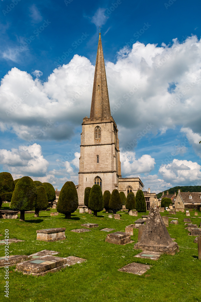 An ancient church and graveyard in the scenic Cotswolds area of England on a summers day (Painswick)