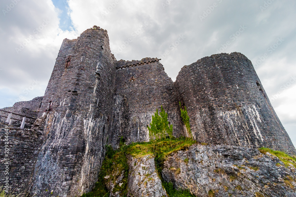 Imposing exterior walls of an ancient ruined castle (Carreg Cennen, Wales)