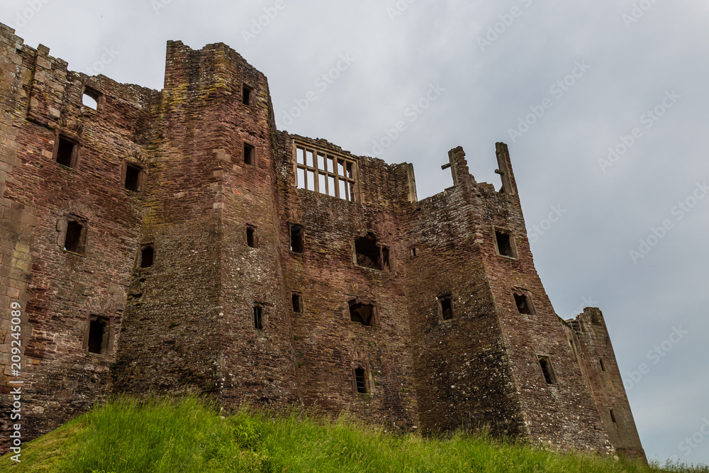 The exterior walls of a ruined medieval castle (Raglan Castle)