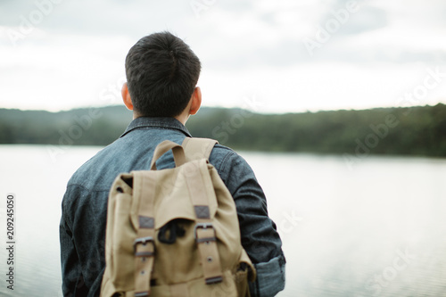 Wallpaper Mural Young Asian man traveling backpacker at park,Travel concept Torontodigital.ca