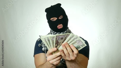 male terrorist shows lots of money