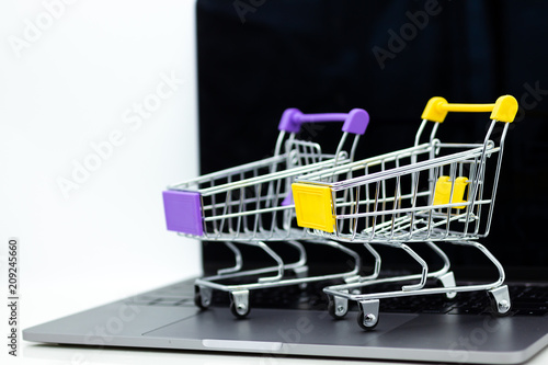 Shopping cart for retail business on notebook. Image use for online and offline shopping, marketing place world wide.