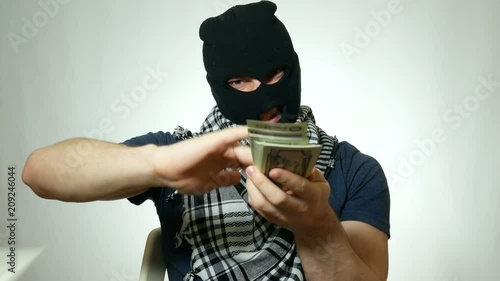 male terrorist throws money