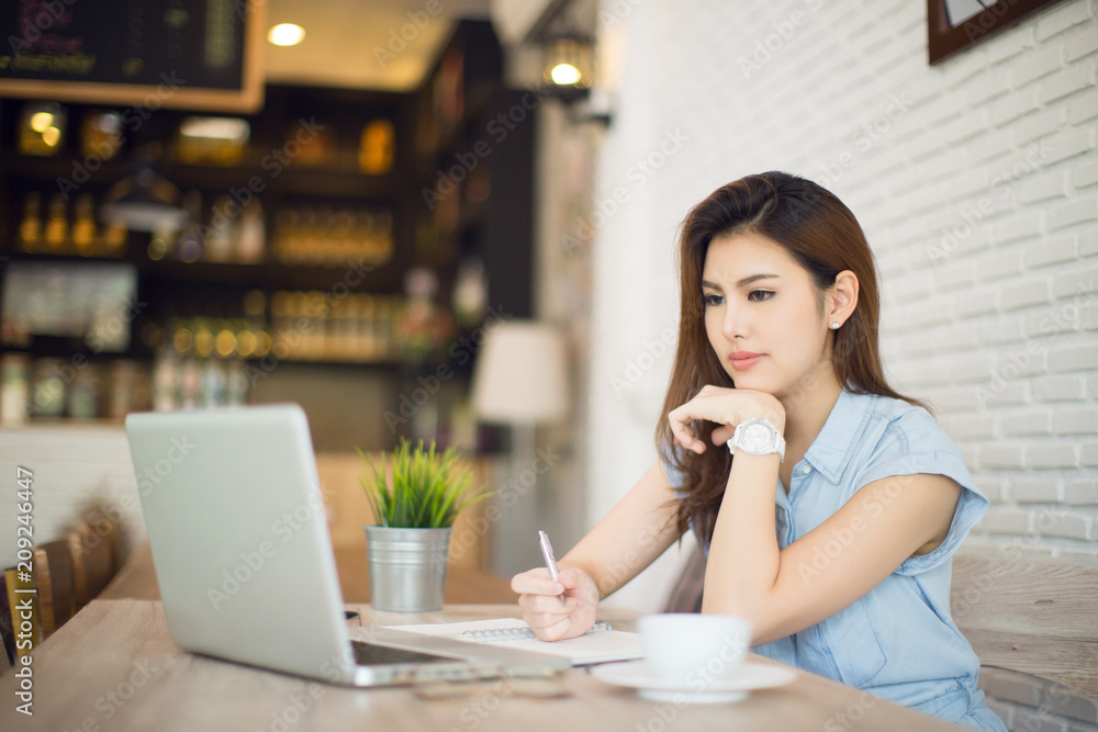 woman works at laptop in a cafe, woman's fingers typing on the keyboard. Workplace in a cafe, a cup of coffee next to a laptop, toned bright sunny photo woman works at laptop in a cafe, woman's fingers typing on the keyboard. Workplace in a cafe, a cup of coffee next to a laptop, toned bright sunny photo