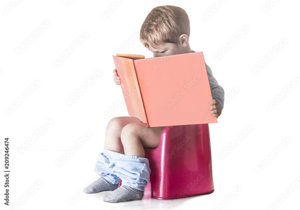 Baby sitting on chamber pot reading a book Baby sitting on chamber pot reading a book