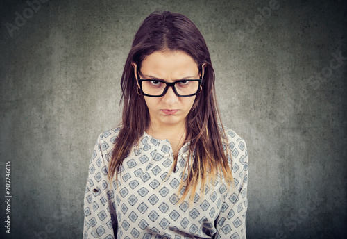 Fotografie, Obraz Young serious angry woman in glasses