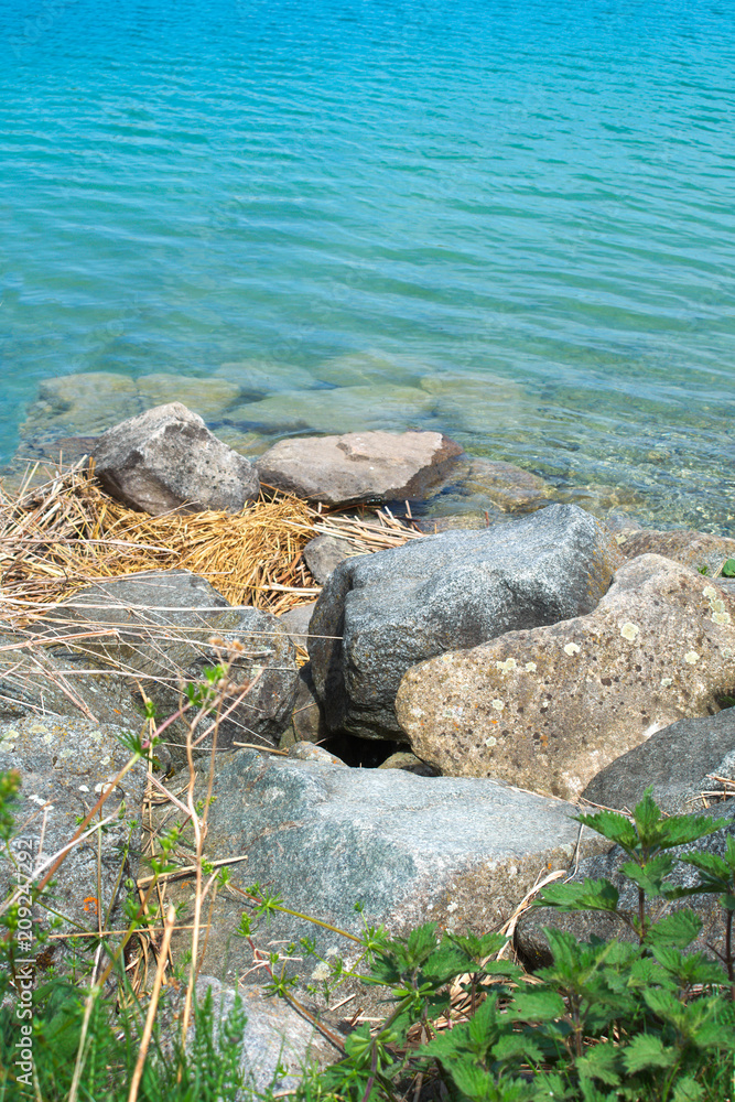 Stones with some straw as nest leading to water