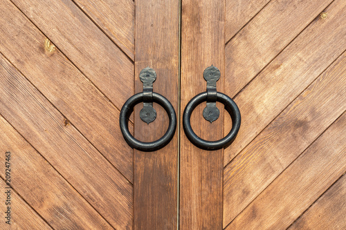Traditional russian massive wooden gate with metal knobs