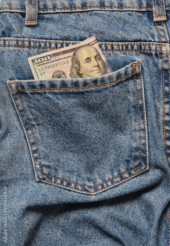 One hundred dollar bills in the back pocket of the rumpled jeans. One hundred dollar bills in the back pocket of the rumpled jeans.