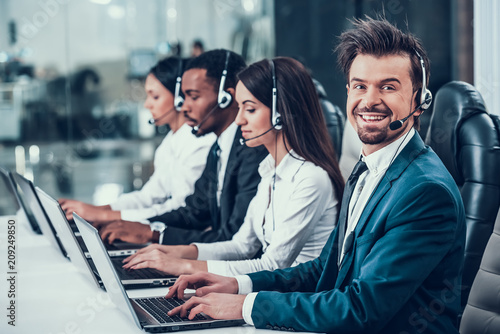 Multicultural young happy employees in call center