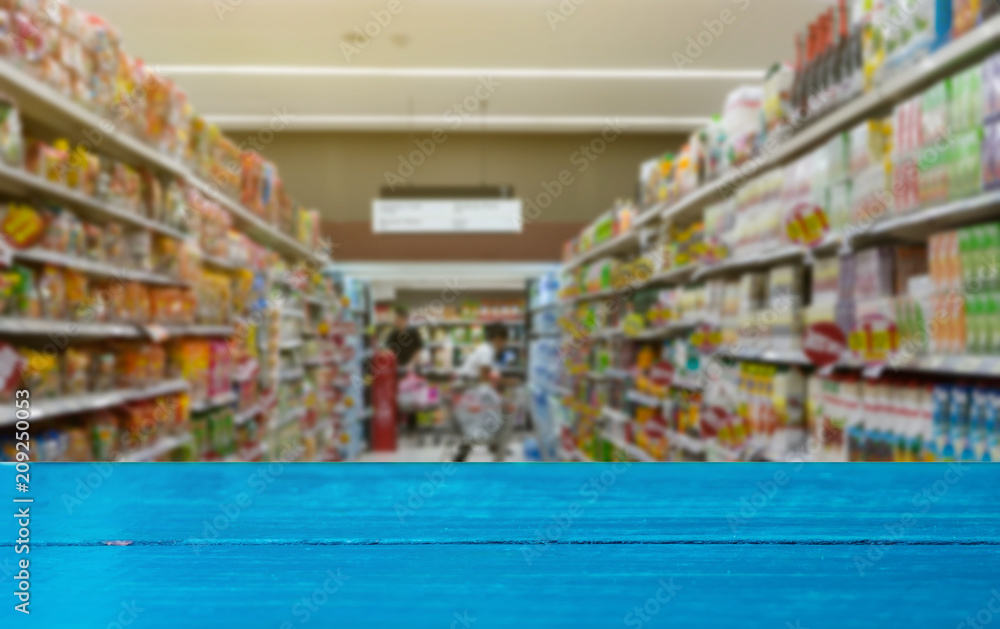Wooden board of blue on blur supermarket.