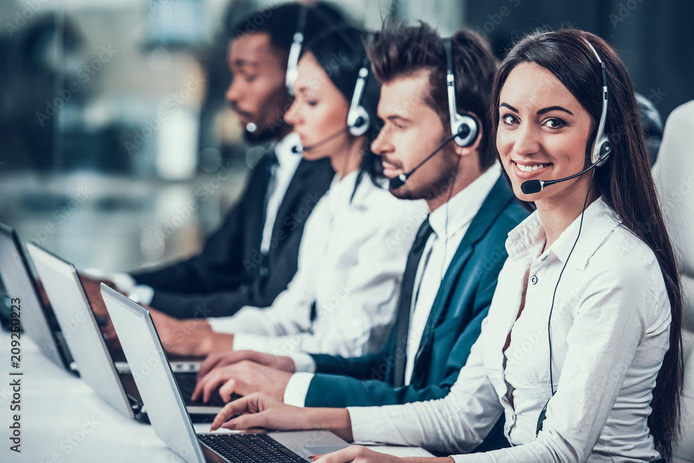 Multicultural young happy employees in call center
