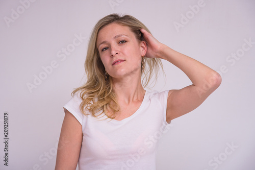 portrait of a beautiful blonde girl on a white background in different poses with different emotions.