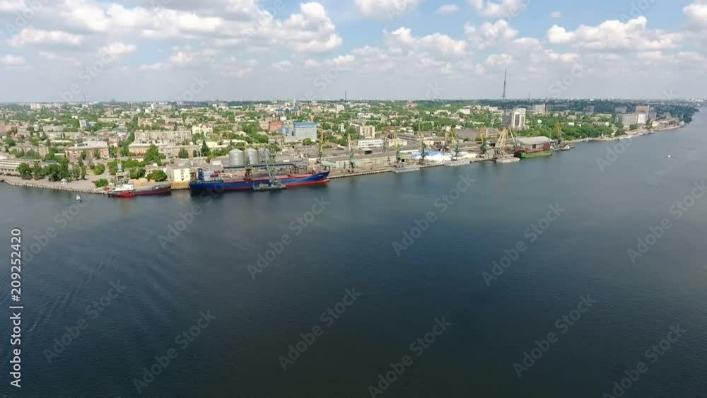 A wonderful bird`s view of a high metallic cranes, docks and storehouses on the Dnipro bank and urban landscape in summer A wonderful bird`s view of a high metallic cranes, docks and storehouses on the Dnipro bank and urban landscape in summer