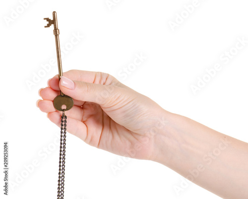Bronze key in hand on a white background isolation