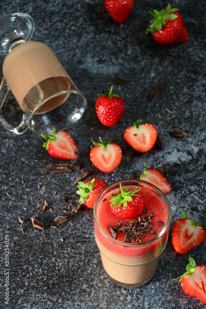 Chocolate panna cotta with strawberry isolated on black