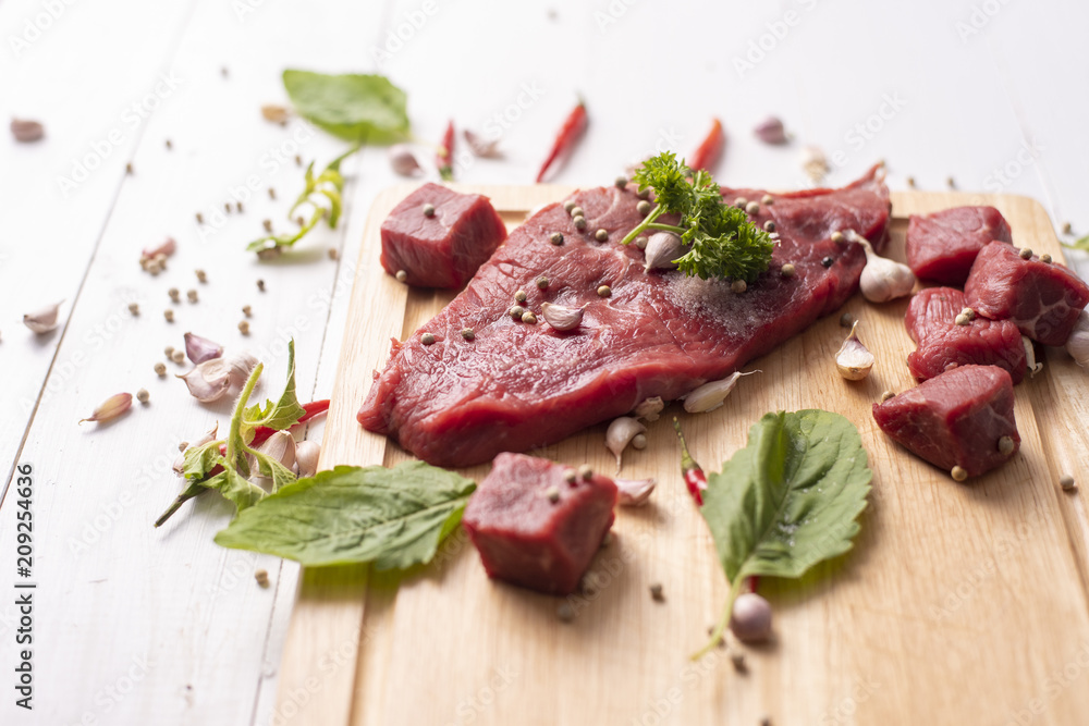 Fototapeta premium Raw beef on white wood background