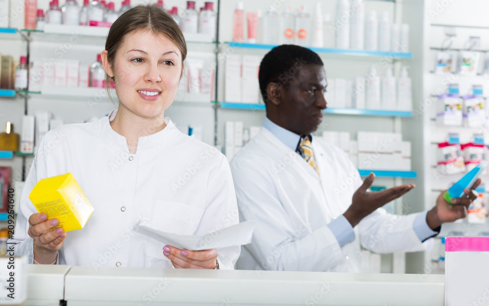 woman pharmacist picking up prescription medicines