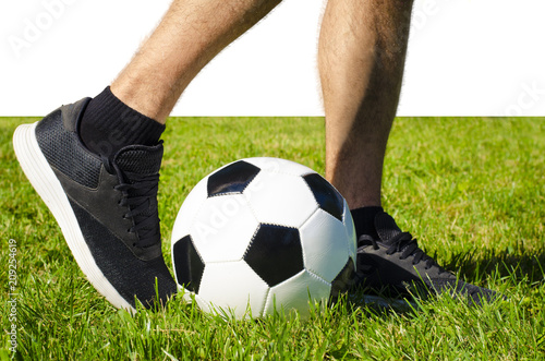 The man's leg in sneakers and soccer ball isolated white background with copy space use for sport and athletic topic © Jelena Ivanovic