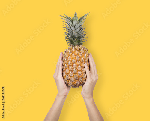 Creative Ripe pineapple on yellow background. fruit for tropical.