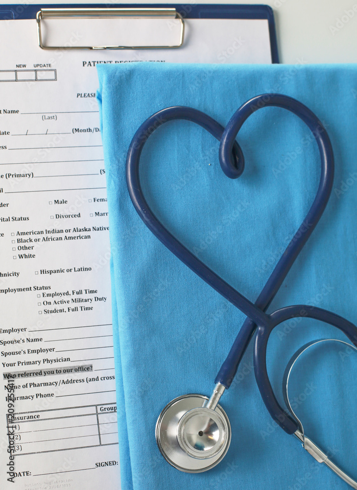 A stethoscope shaping a heart on a medical uniform, closeup, selective focus A stethoscope shaping a heart on a medical uniform, closeup, selective focus