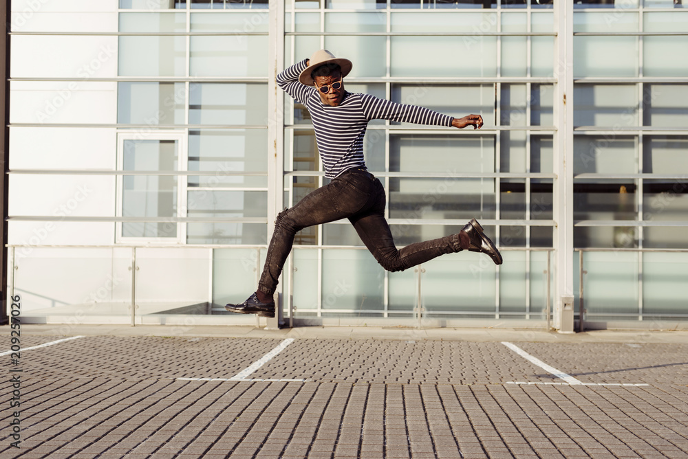 Stylish black man jumping on street Stock Photo Adobe Stock