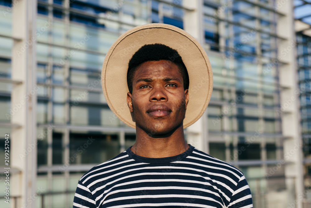 Stylish black man posing on street Stylish black man posing on street