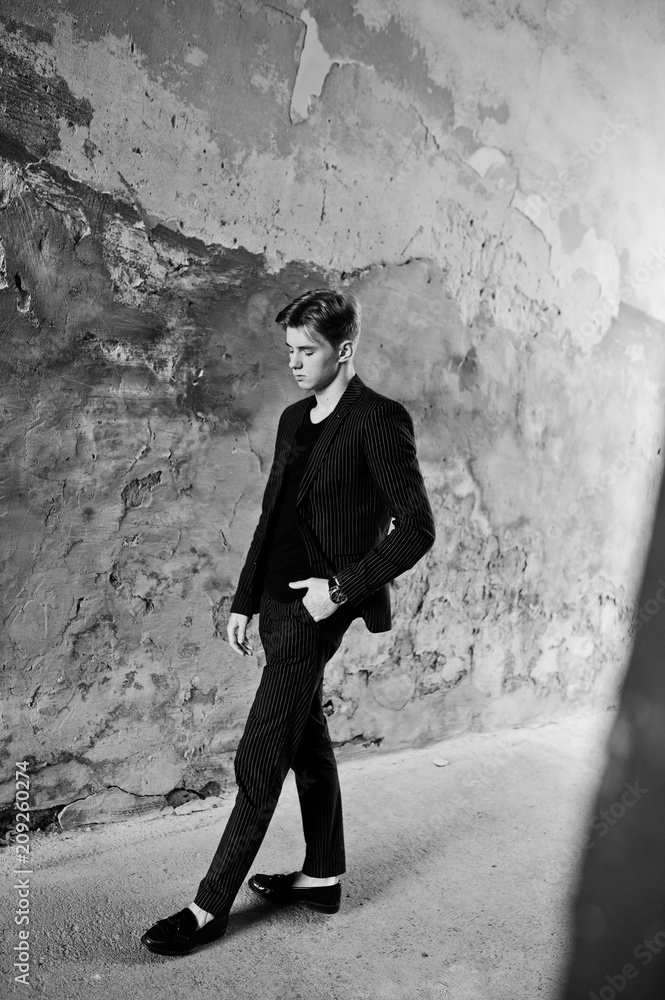 Young stylish macho boy in black jacket posed outdoor of street. Amazing model man. Young stylish macho boy in black jacket posed outdoor of street. Amazing model man.