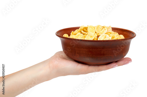 bowl of corn flakes with hand isolated on white background