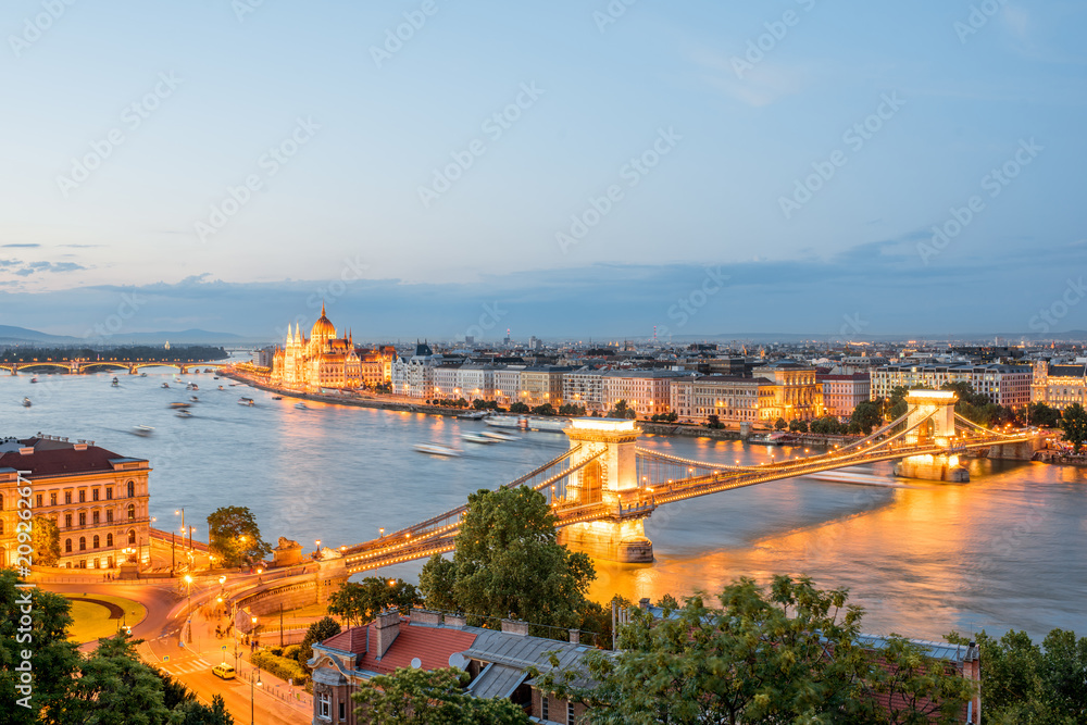 Aerial cityscape view with illuminated Chain bridge and famous Parliament building during the twilight in Budapest, Hungary