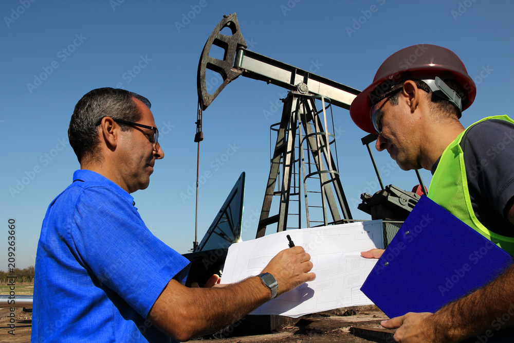 Petroleum Engineers Discussing Issues at Work / Petroleum engineers