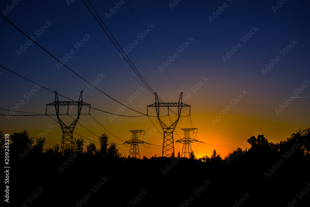 high-voltage power lines at sunset. electricity distribution station .