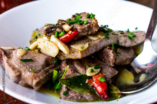 A close up of lamb chops with garlic and chilli