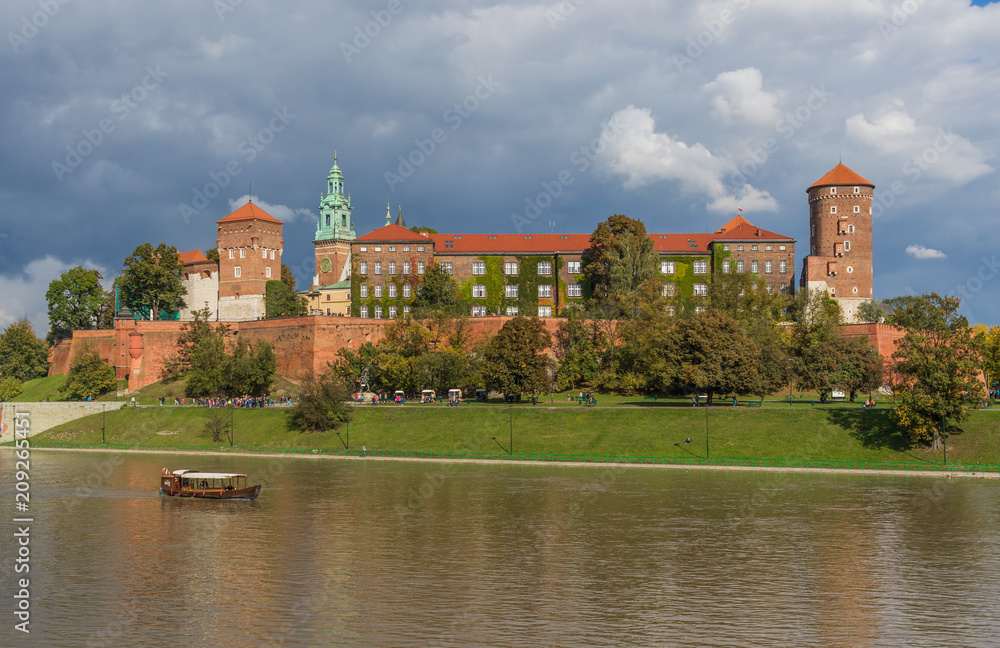 Fototapeta premium Krakow, Poland - the second biggest city in Poland, Krakow offers a mix of history and modernity. Here in the picture a perspective of the Old Town and the famous Wawel Castle, on the Vistula river