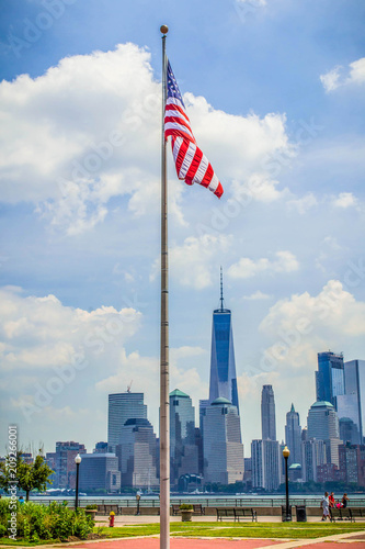 American Flag With New York City Skyline In The Background