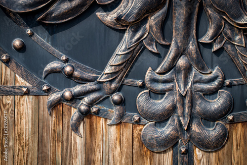 wooden gate with wrought iron elements close up